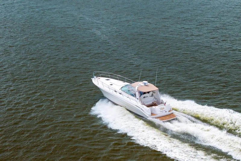 Slide: The Image of 2002 Sea Ray 410 Express Cruiser speeding on open water. - 38
