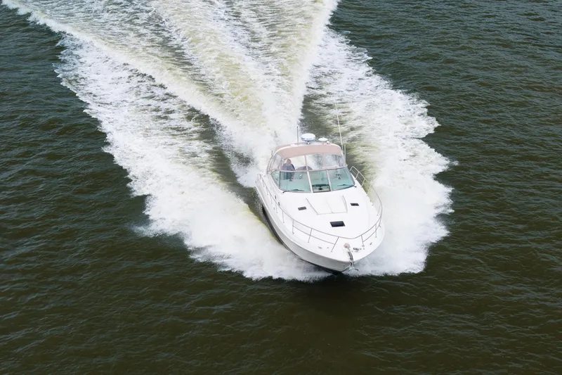 Slide: The Image of 2002 Sea Ray 410 Express Cruiser speeding on open water, creating a dynamic wake. - 5