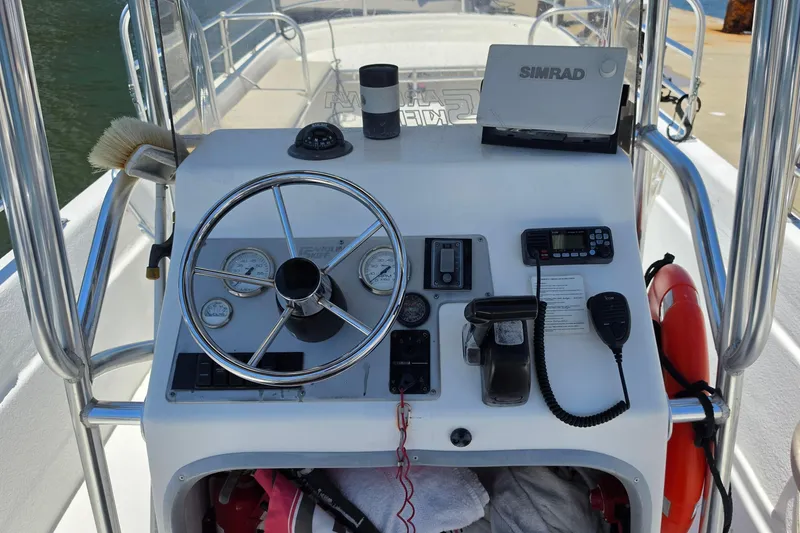 Slide: The Image of Console of a 2011 Carolina Skiff 258 DLV boat with steering wheel and navigation equipment. - 5