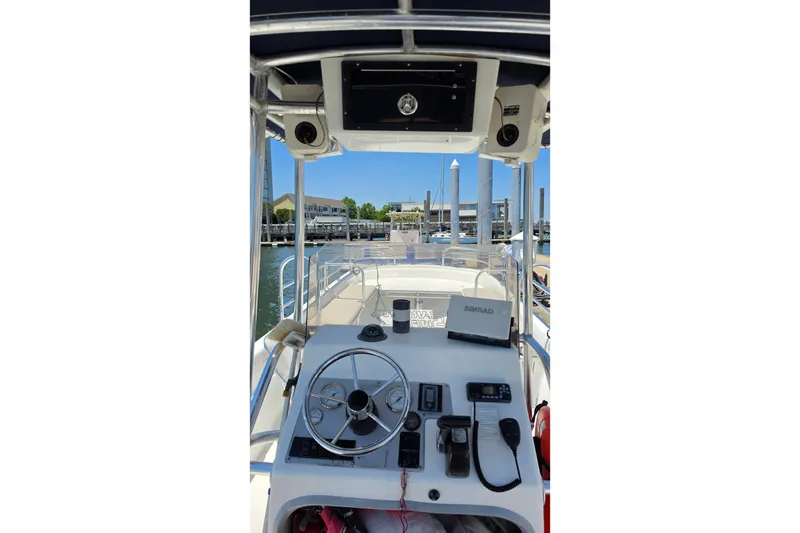 Slide: The Image of 2011 Carolina Skiff 258 DLV boat dashboard with steering wheel and navigation equipment. - 6