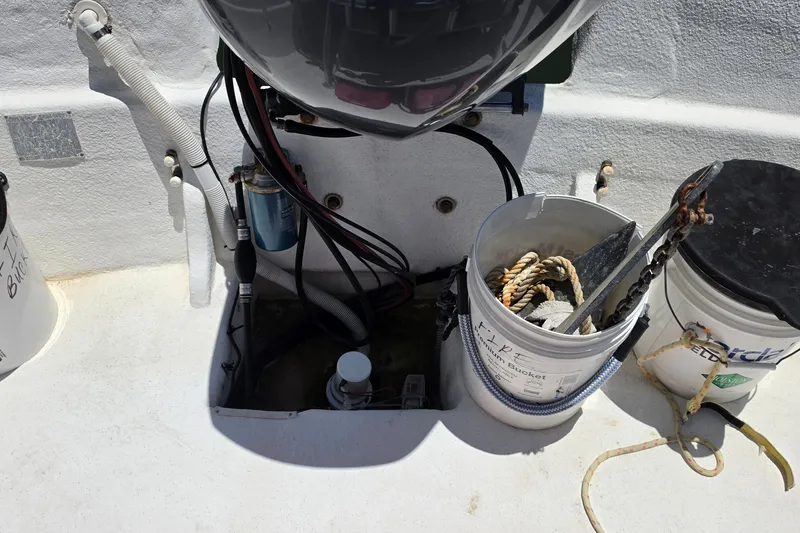 Slide: The Image of 2011 Carolina Skiff 258 DLV boat deck with equipment and storage buckets. - 8