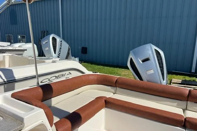 Slide: The Image of 2020 Key West 239 DFS boat with brown seating, Honda outboard motors, and Cobia branding. - 10