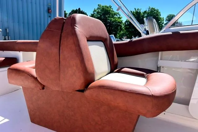 Slide: The Image of 2020 Key West 239 DFS boat seat with brown and white upholstery, outdoor setting. - 12