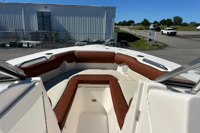 Slide: The Image of 2020 Key West 239 DFS boat with brown seating, docked near industrial buildings. - 13