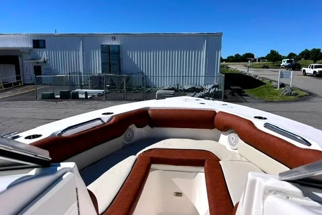 Slide: The Image of 2020 Key West 239 DFS boat with brown and white seating, docked near industrial building. - 14