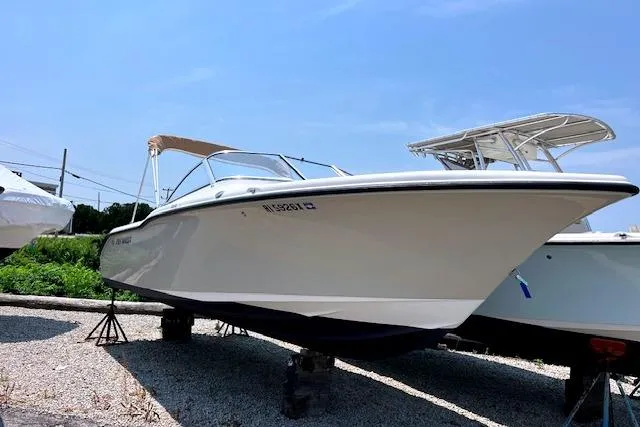 Slide: The Image of 2020 Key West 239 DFS boat on display, white hull, parked on gravel. - 2