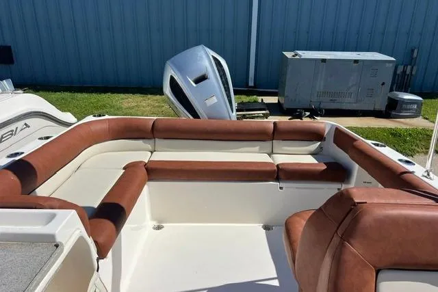 Slide: The Image of 2020 Key West 239 DFS boat interior with brown seating, outdoor setting. - 9