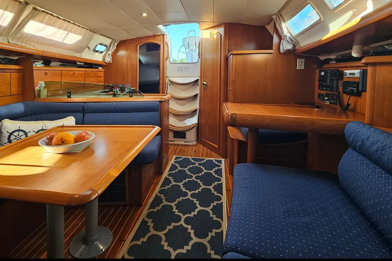 Slide: The Image of Interior of 2002 Jeanneau Sun Odyssey 37 sailboat with cozy seating and wooden finishes. - 15