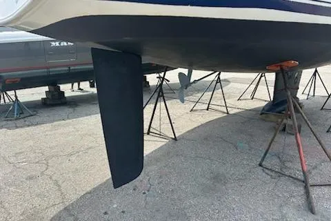 Slide: The Image of 2002 Jeanneau Sun Odyssey 37 sailboat on stands, showing keel and propeller. - 28