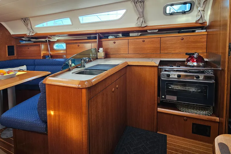 Slide: The Image of Interior of 2002 Jeanneau Sun Odyssey 37 yacht with kitchen and dining area. - 18