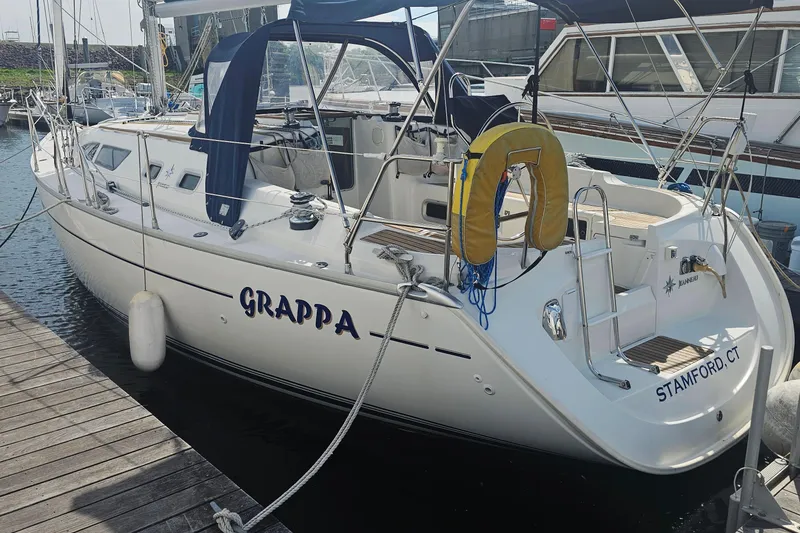 Slide: The Image of 2002 Jeanneau Sun Odyssey 37 sailboat docked, featuring "Grappa" name and Stamford, CT location. - 2