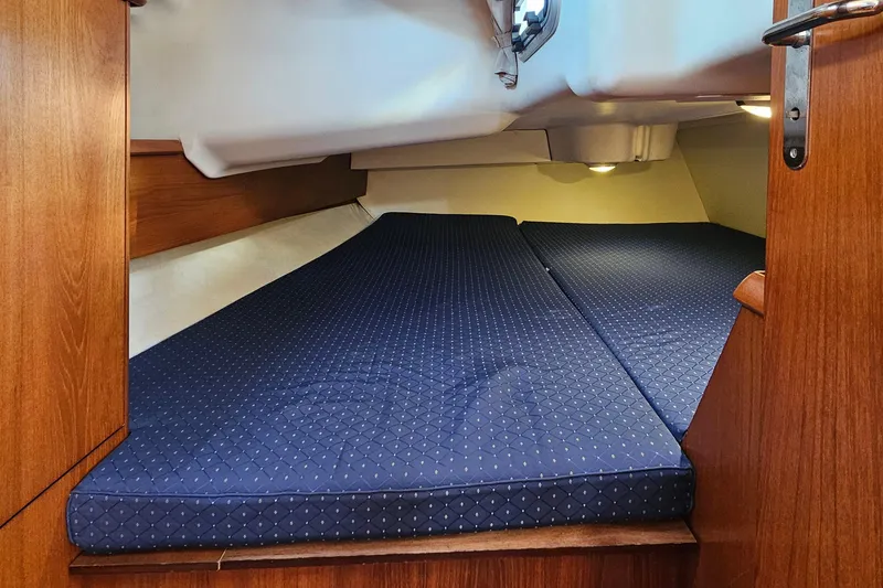 Slide: The Image of Cozy cabin interior of 2002 Jeanneau Sun Odyssey 37 sailboat with blue mattress. - 24