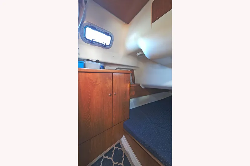 Slide: The Image of Interior cabin of 2002 Jeanneau Sun Odyssey 37 sailboat with wooden cabinetry. - 25