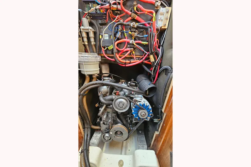 Slide: The Image of Engine compartment of a 2002 Jeanneau Sun Odyssey 37 sailboat, showing wiring and components. - 26