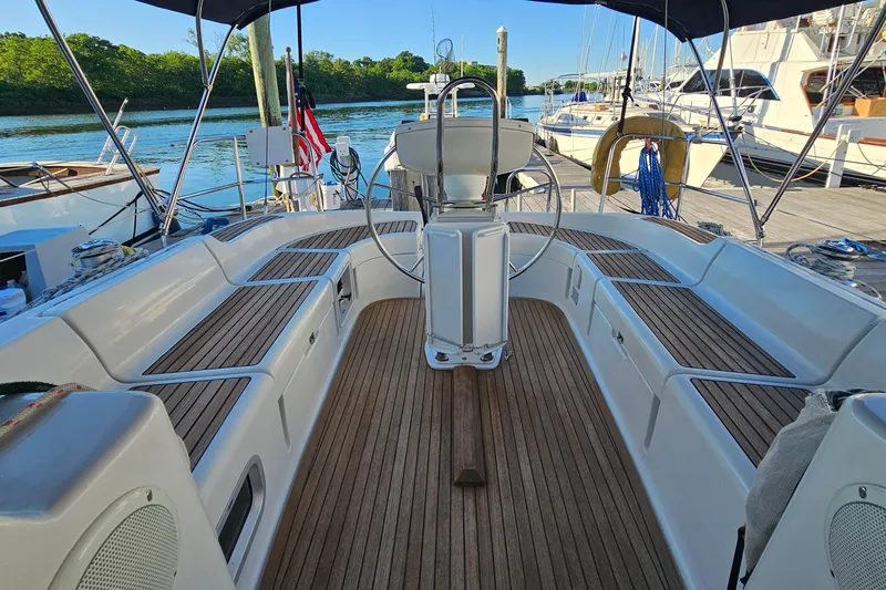Slide: The Image of Cockpit of 2002 Jeanneau Sun Odyssey 37 sailboat with wooden seating and steering wheel. - 5