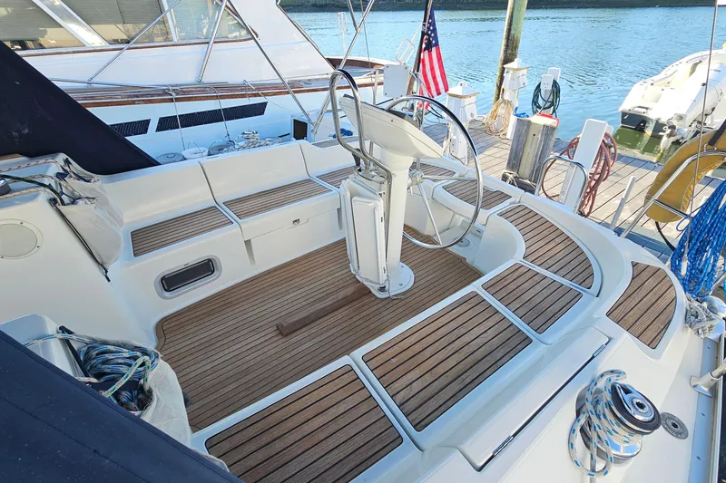 Slide: The Image of Cockpit of 2002 Jeanneau Sun Odyssey 37 sailboat with wooden deck and steering wheel. - 7