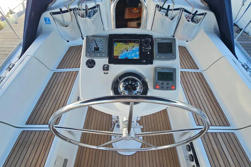 Slide: The Image of Cockpit of 2002 Jeanneau Sun Odyssey 37 sailboat with navigation instruments and teak flooring. - 8