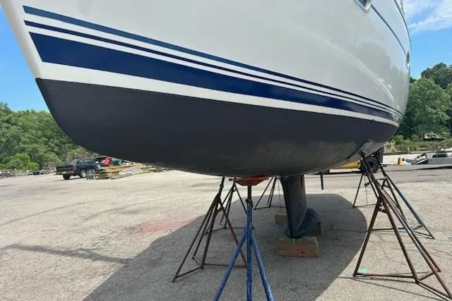 Slide: The Image of 2002 Jeanneau Sun Odyssey 37 sailboat on stands, showcasing hull and keel. - 29