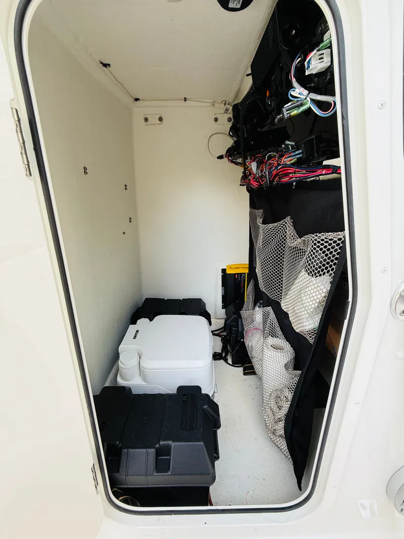 Slide: The Image of Interior of a Parker 21 boat with storage and wiring. - 18