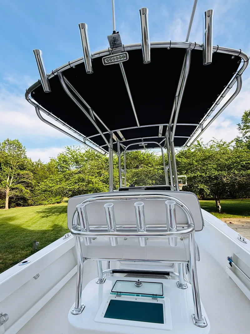 Slide: The Image of 2024 Parker 21 boat with T-top and fishing rod holders. - 19
