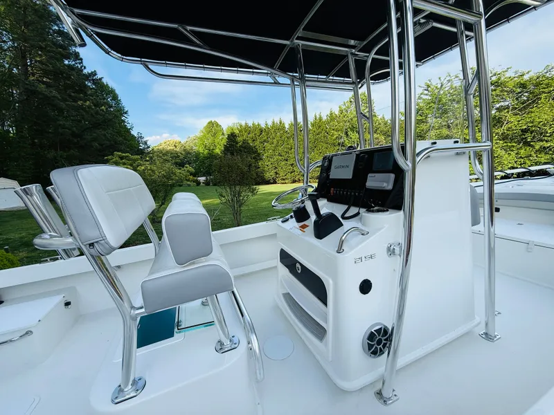 Slide: The Image of 2024 Parker 21 boat with modern helm console and seating area. - 25