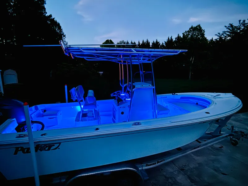 Slide: The Image of 2024 Parker 21 boat with blue LED lighting at dusk. - 27