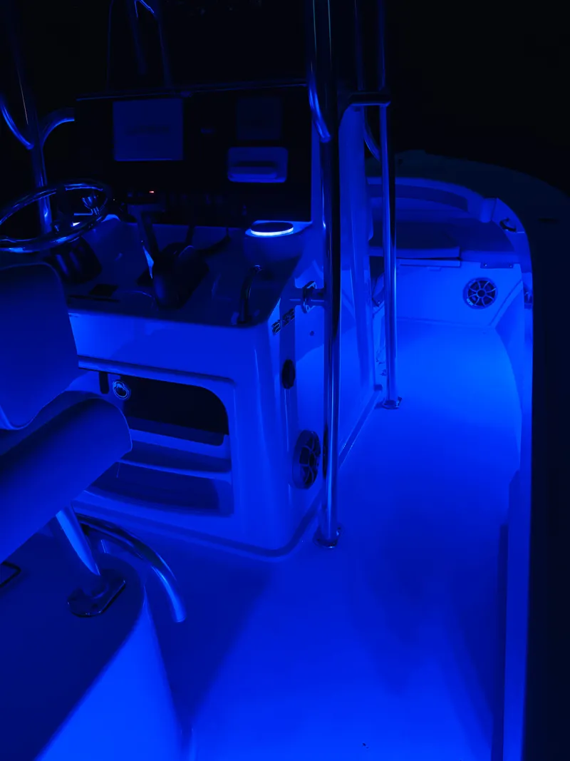 Slide: The Image of Illuminated cockpit of a Parker 21 boat, 2024 model, in blue lighting. - 32