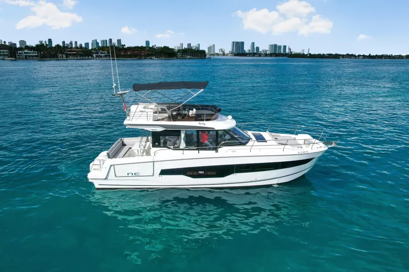 The Image of 2025 Jeanneau NC 1295 Fly yacht cruising on clear blue water. - 0