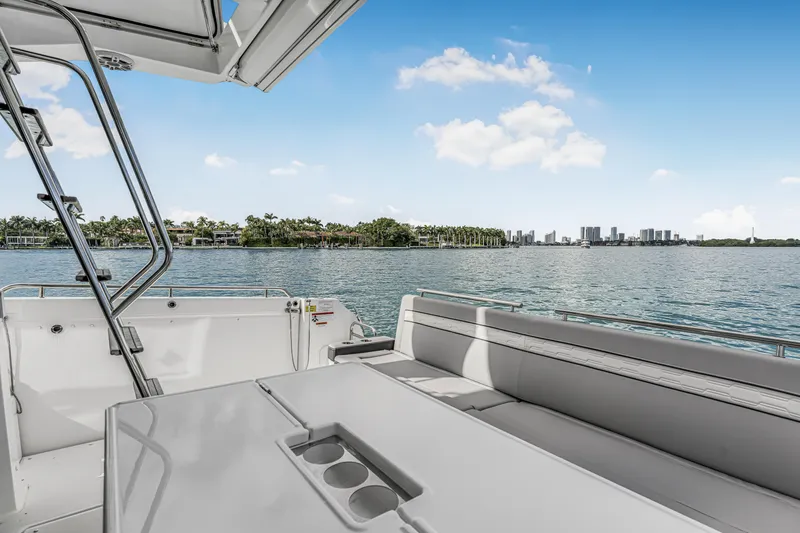 Slide: The Image of 2025 Jeanneau NC 1295 Fly yacht deck with scenic waterfront view. - 10
