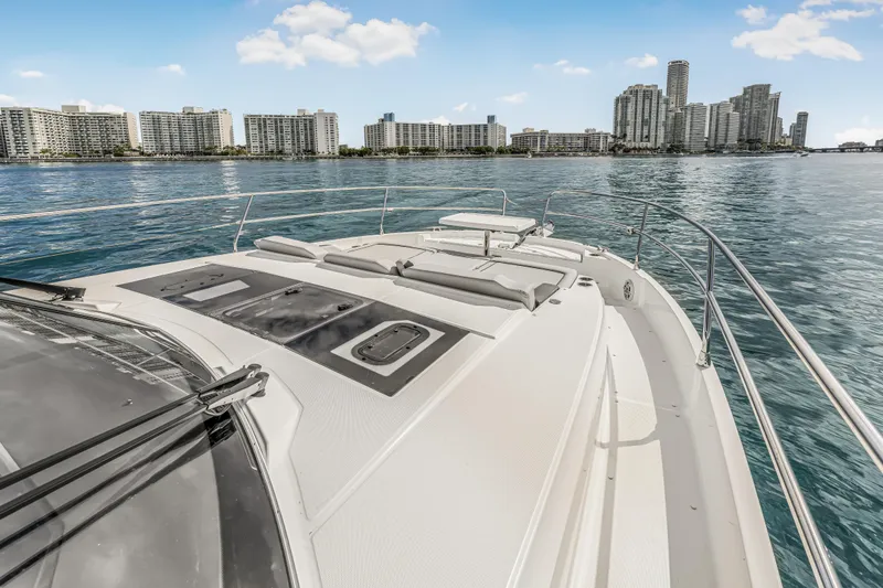 Slide: The Image of 2025 Jeanneau NC 1295 Fly yacht with city skyline in the background. - 11