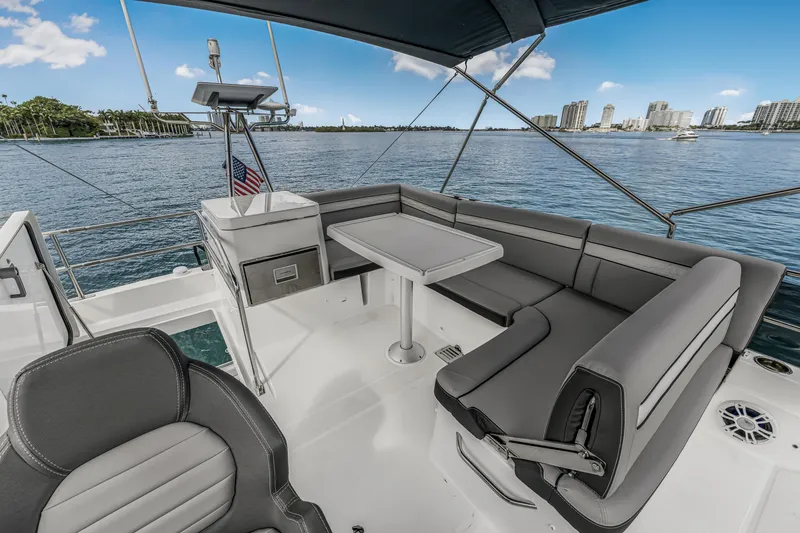 Slide: The Image of 2025 Jeanneau NC 1295 Fly yacht with elegant seating and scenic waterfront view. - 17