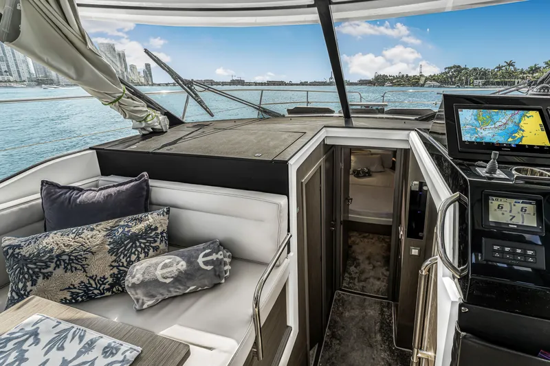 Slide: The Image of 2025 Jeanneau NC 1295 Fly yacht interior with navigation system and cozy seating area. - 28