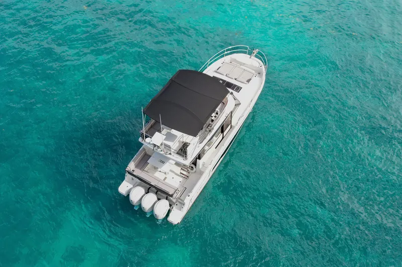 Slide: The Image of 2025 Jeanneau NC 1295 Fly yacht on clear turquoise water, aerial view. - 3