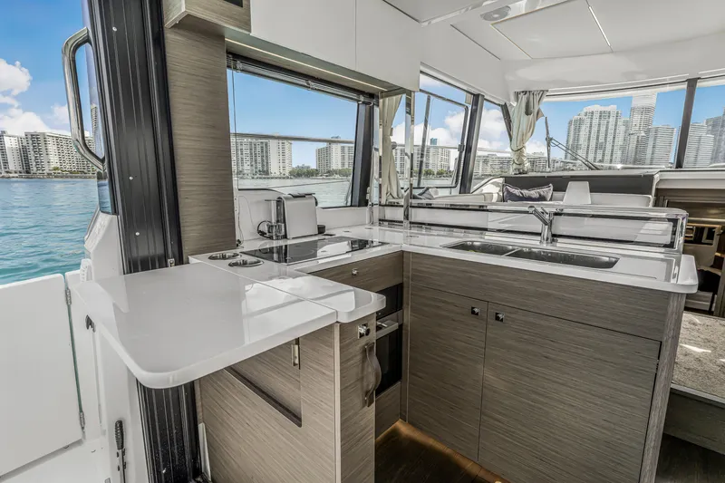Slide: The Image of Modern kitchen interior on 2025 Jeanneau NC 1295 Fly yacht with cityscape view. - 9