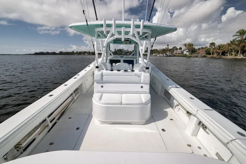 Slide: The Image of 2017 Yellowfin 39 Offshore boat on calm waters, showcasing spacious deck and seating. - 10