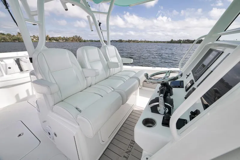 Slide: The Image of 2017 Yellowfin 39 Offshore boat interior with white seating and modern helm controls. - 11