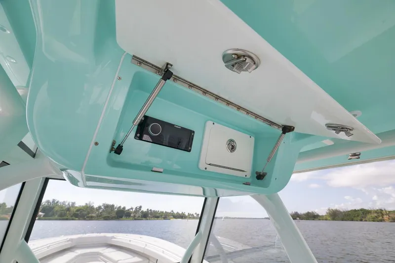 Slide: The Image of 2017 Yellowfin 39 Offshore boat interior with open storage compartment and electronics. - 13