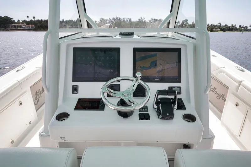 Slide: The Image of 2017 Yellowfin 39 Offshore boat helm with dual navigation screens and steering wheel. - 14