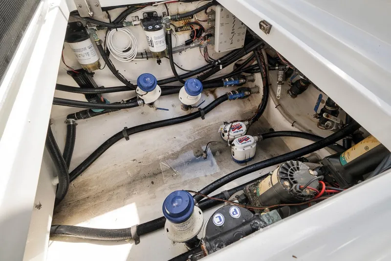Slide: The Image of Engine compartment of a 2017 Yellowfin 39 Offshore boat, showcasing mechanical components and wiring. - 18