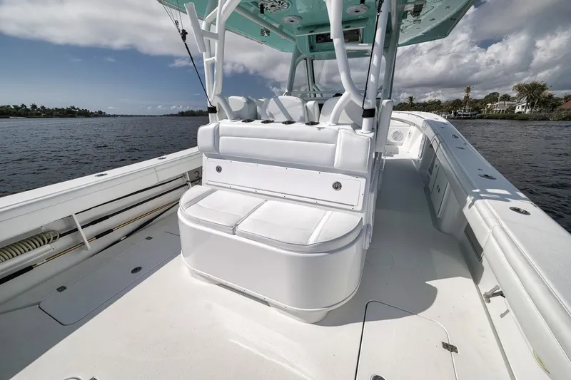 Slide: The Image of 2017 Yellowfin 39 Offshore boat interior with white seating, on a calm waterway. - 22