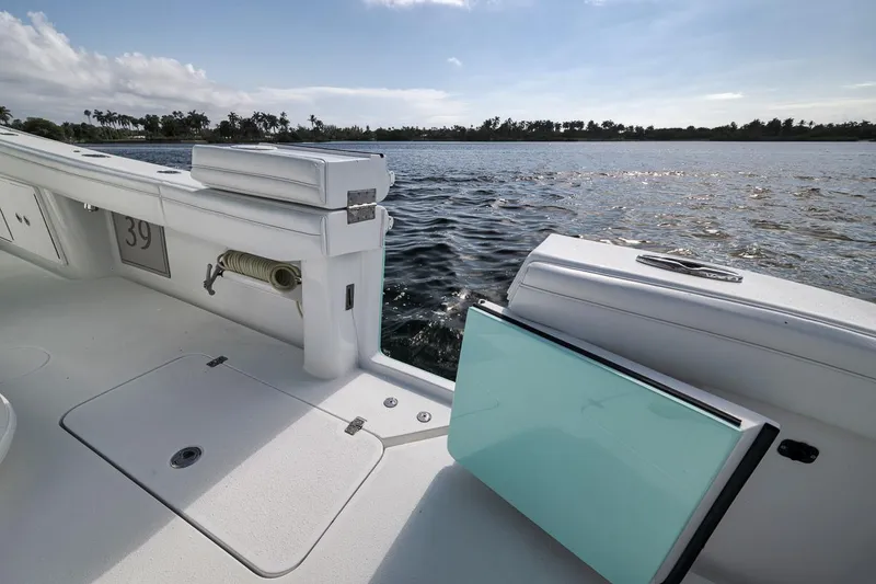 Slide: The Image of 2017 Yellowfin 39 Offshore boat deck with open storage, overlooking calm waters. - 23
