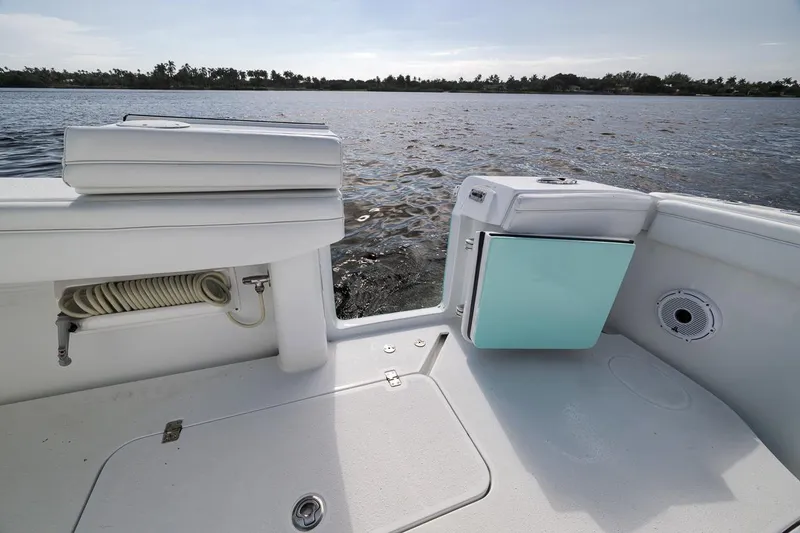 Slide: The Image of 2017 Yellowfin 39 Offshore boat deck with storage and hose, near calm waters. - 24