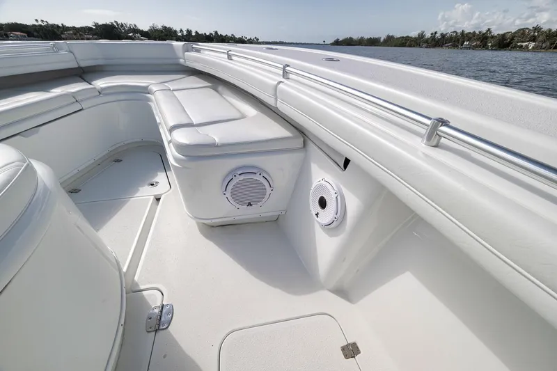 Slide: The Image of 2017 Yellowfin 39 Offshore boat interior with white seating and speaker, near water. - 6