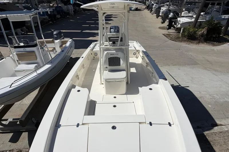 Slide: The Image of 2022 Pathfinder 2600 HPS boat docked, showcasing spacious deck and seating area. - 12