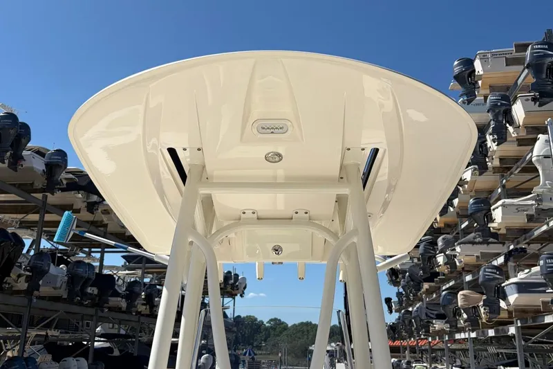Slide: The Image of 2022 Pathfinder 2600 HPS boat with T-top, surrounded by stacked outboard motors. - 13