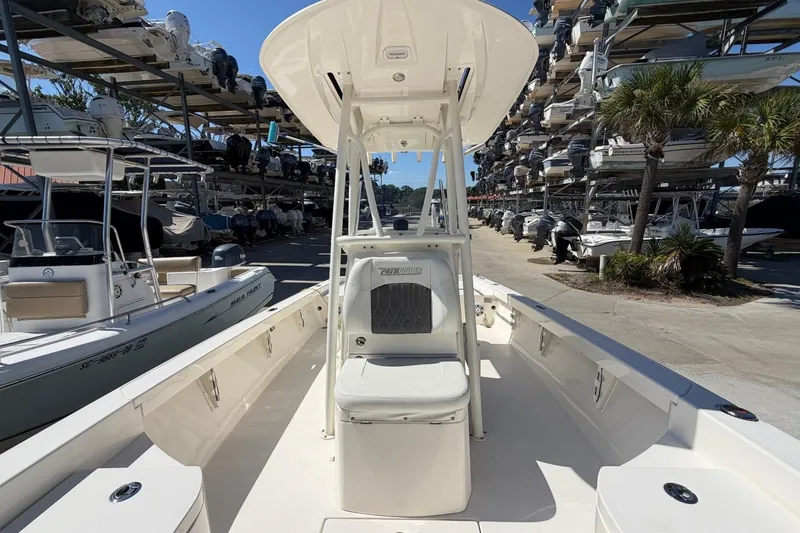 Slide: The Image of 2022 Pathfinder 2600 HPS boat in marina, surrounded by stacked boats and palm trees. - 14