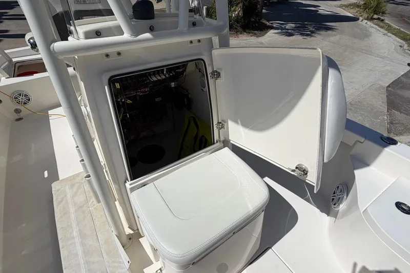 Slide: The Image of 2022 Pathfinder 2600 HPS boat interior with open storage compartment and seating. - 17
