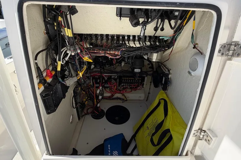 Slide: The Image of Electrical compartment of a 2022 Pathfinder 2600 HPS boat, showcasing wiring and equipment. - 18