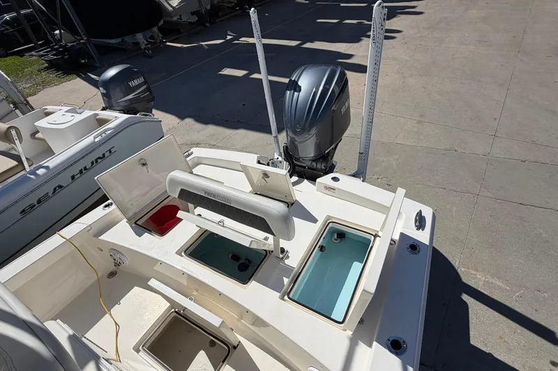 Slide: The Image of 2022 Pathfinder 2600 HPS boat with Yamaha outboard engine and open storage compartments. - 19