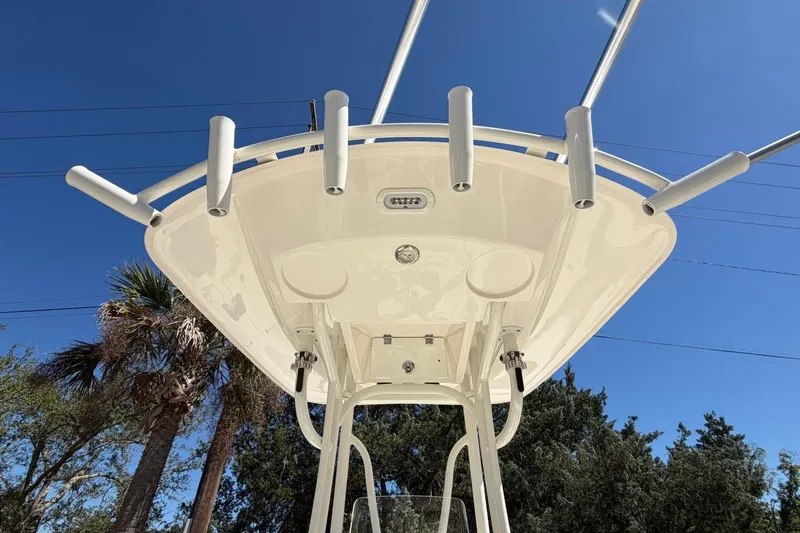 Slide: The Image of 2022 Pathfinder 2600 HPS boat with rod holders against a clear blue sky. - 21